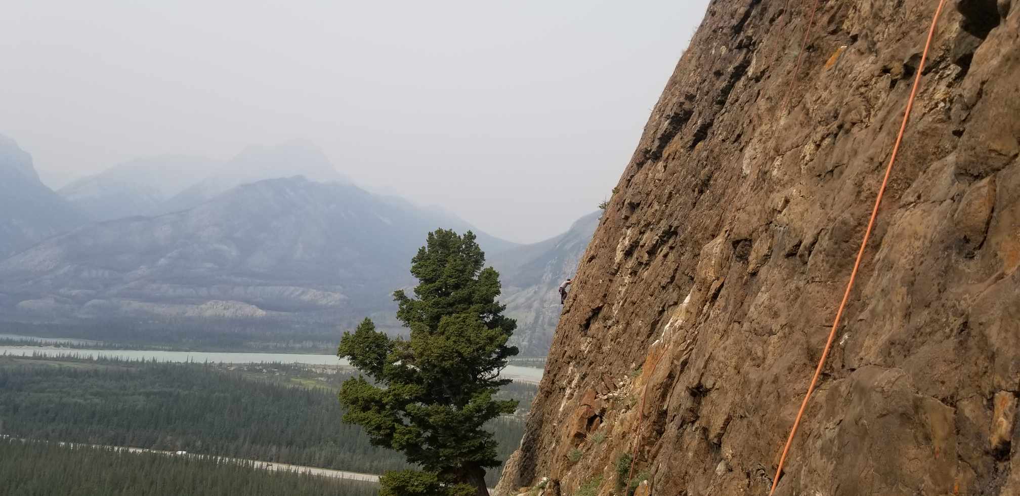 A picture of a cliff with the names of rock climbing routes. Right hand side of the crag.