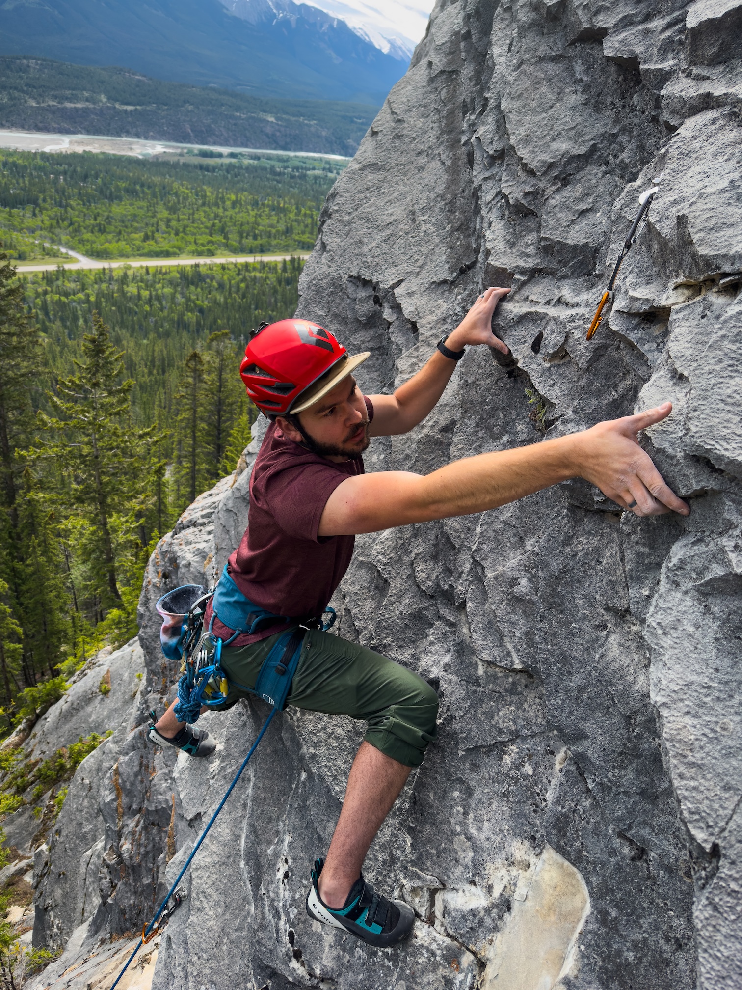 Climber stretched out to the right to grasp a sidepull.