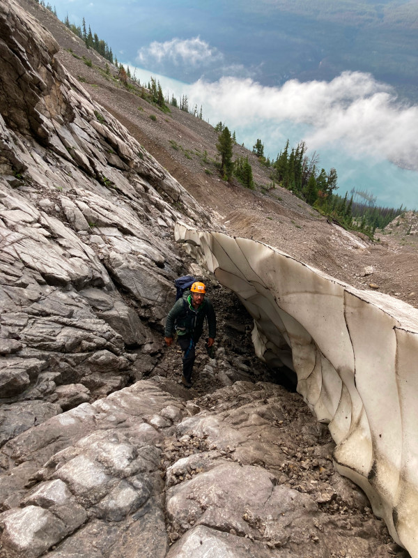 Picture of man hiking steeply alongside glacier